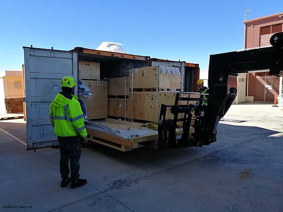 The shipping containers are unloaded at the DKIST telescope.